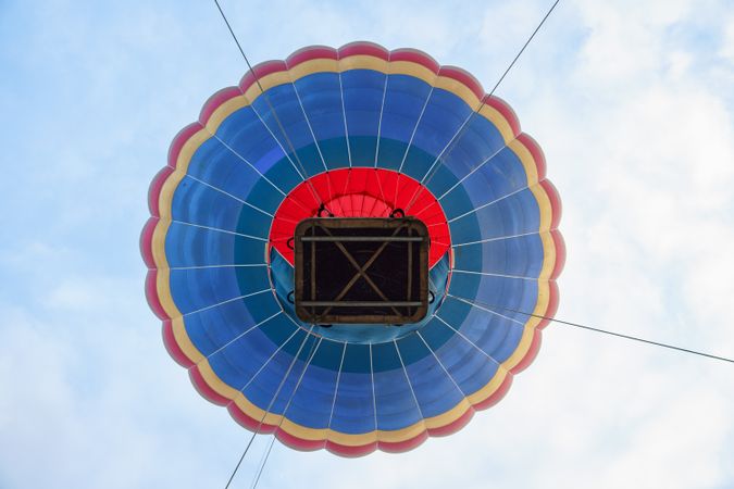 Bottom of hot air balloon basket ascending in Aeroestacion Festival in Guadix, Granada, Andalusia, Spain