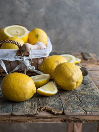 Lemons and reamer placed on wooden board