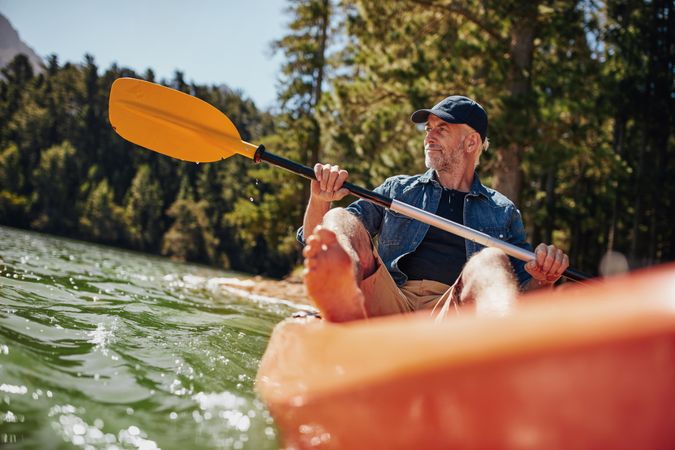 Portrait of a mature man with kayak in a lake