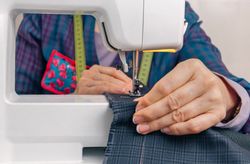 Seamstress hands working on a sewing machine