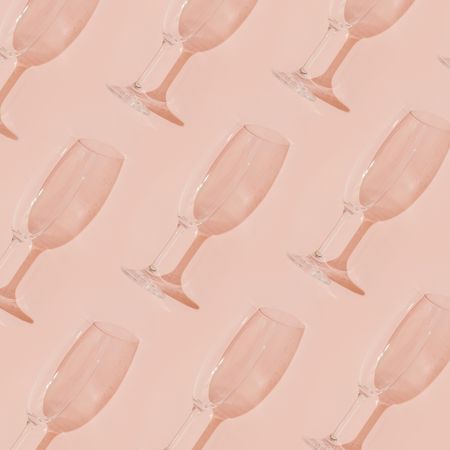 Champagne glass pattern on pastel coral background