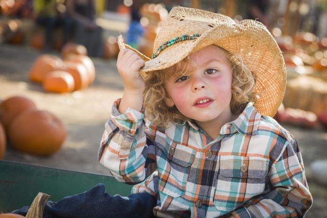 Little Boy in Cowboy Hat at Pumpkin Patch