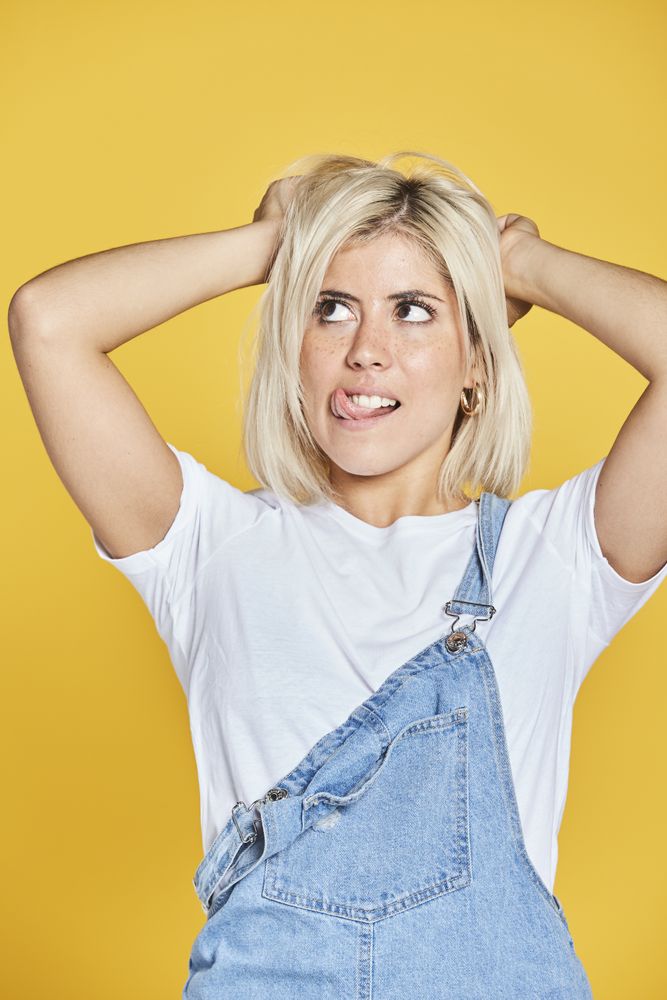 Trendy blonde female in denim sundress