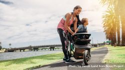 Woman taking her baby in a baby pram during her morning walk 5QnRd4