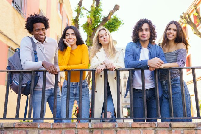 Portrait of happy male and female friends standing in a row