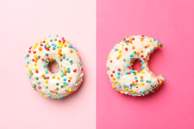 Two tasty donuts on two tone background