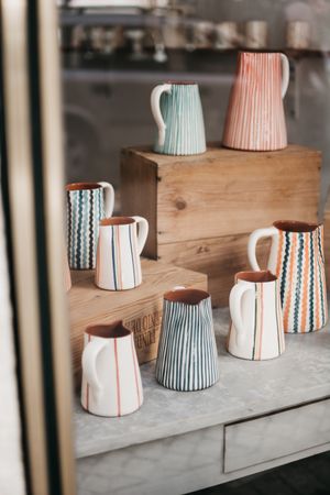 Ceramic jugs behind shop window
