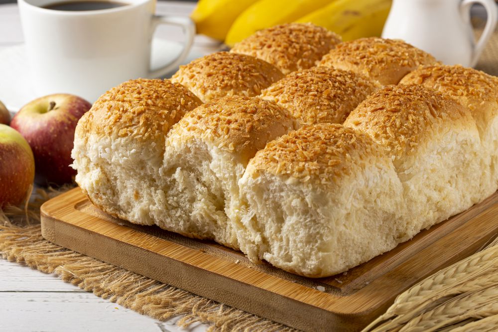 Breakfast table with coconut bread and fruits.