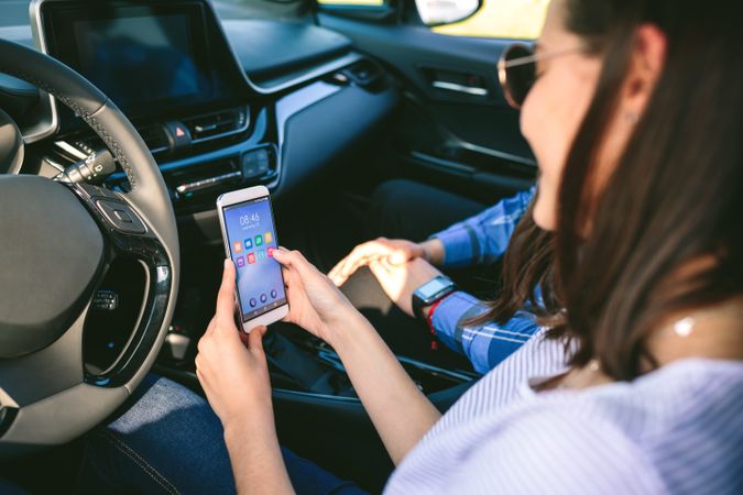 Woman and boyfriend using mobile in the car