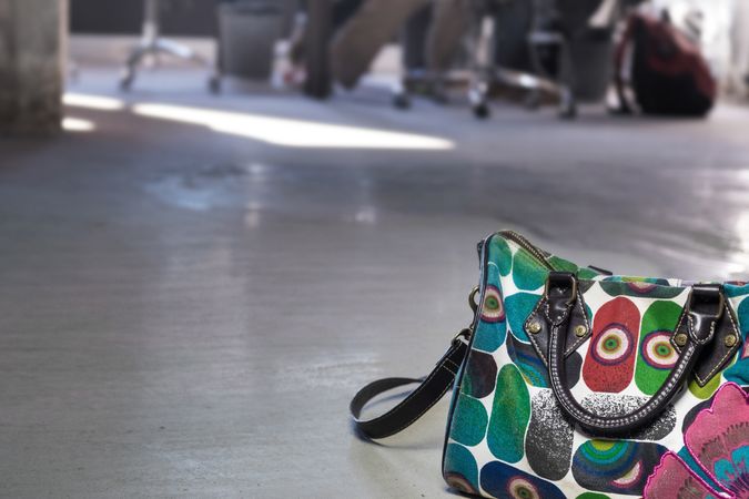 Colorful bag on floor of office with copy space