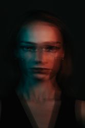 Blurry portrait of young woman in UV light 4NlNl0