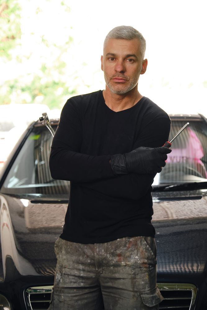 Confident mechanic in garage