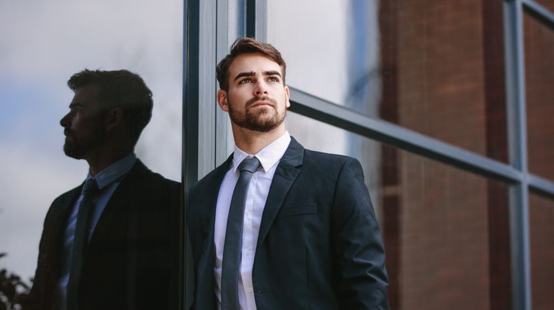 Businessman standing outside and looking away