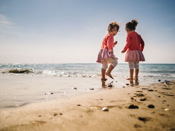 Girls playing on beach in sunny day