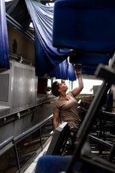 Military woman looking up inside vehicle