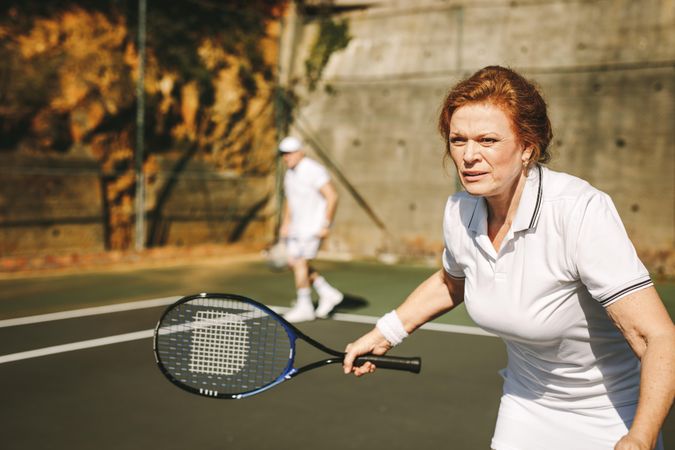 Close up of a mature woman playing tennis on a sunny day