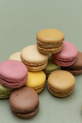 Pile of tasty French macaroons on a green counter