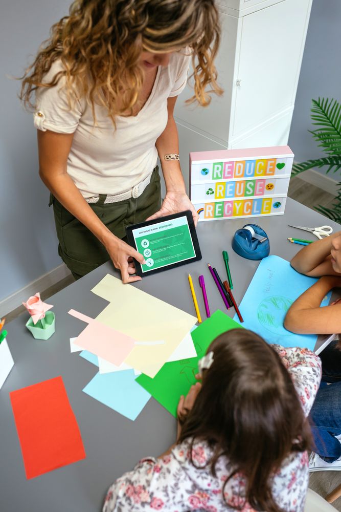 Teacher showing tablet with tips to be more ecological for students in environmental classroom