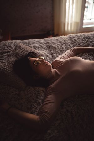 Young woman lying on bed