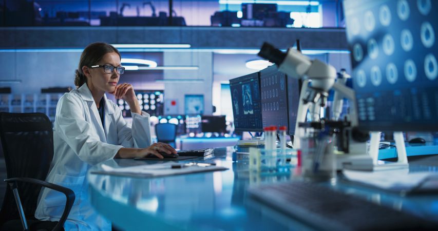 Medical Hospital Research Laboratory: White Female Neurosurgeon Using Computer with Brain Scan MRI Images, Finding Best Treatment for Sick Patient.
