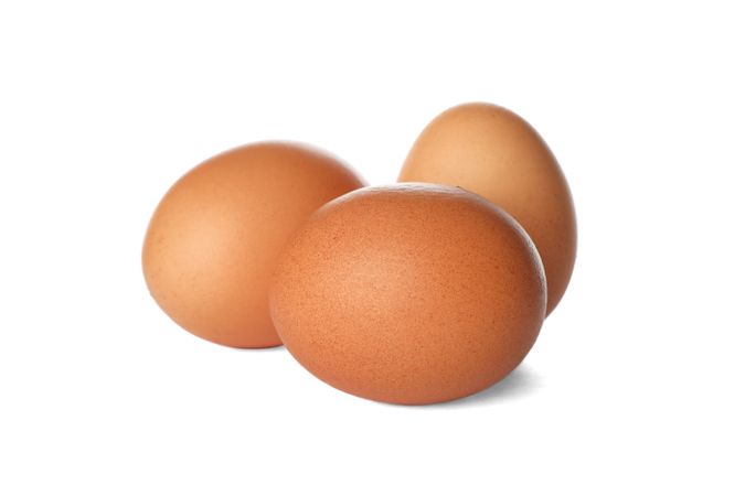 Few raw chicken eggs on plain background