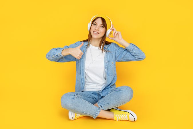 Concept of people, young woman on yellow background