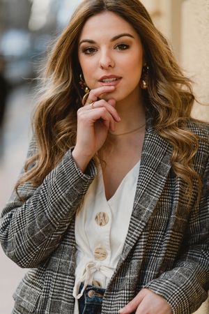 Woman leaning on wall on street