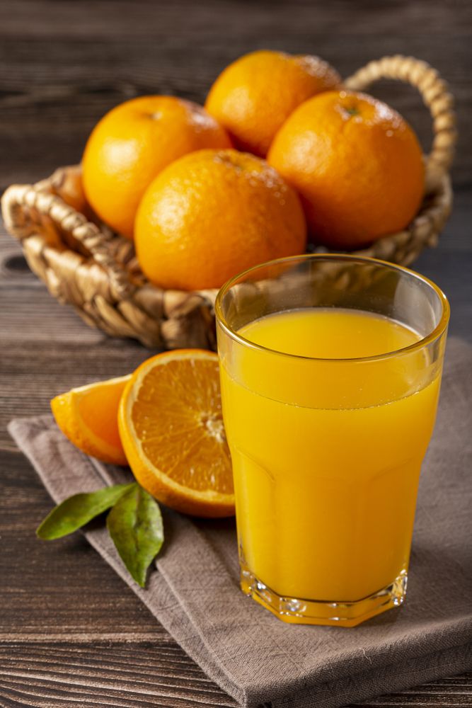 Glass with orange juice on the table.
