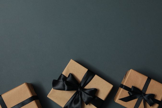 Craft gift boxes with bow on gray background