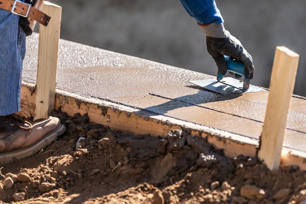 Construction Worker Using Stainless Steel Edger On Wet Cement Forming Coping Around New Pool