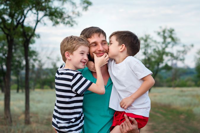 Loving father with two sons outdoors