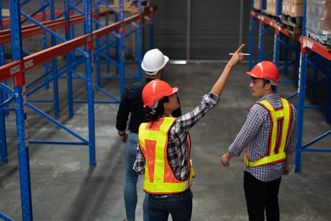 Team of warehouse workers inspecting inventory in a logistics facility.