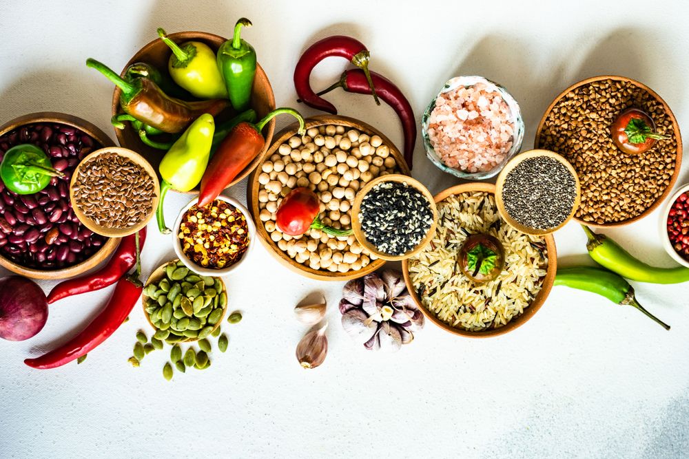 Top view of bowls of legumes and aromatics