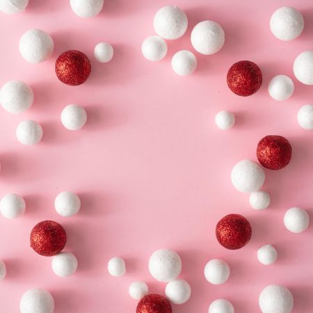 Christmas pink background with copy space made of red and glitter ball decoration