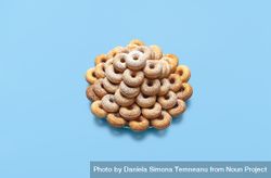 Doughnuts on a plate, isolated on a blue table 0K7Wy0