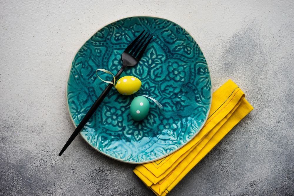 Easter table setting with blue plate and yellow napkin