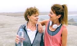 Mature sportswoman talking with female friend