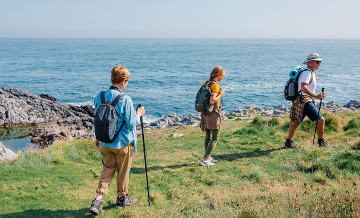 Family hiking near on cliff near the ocean