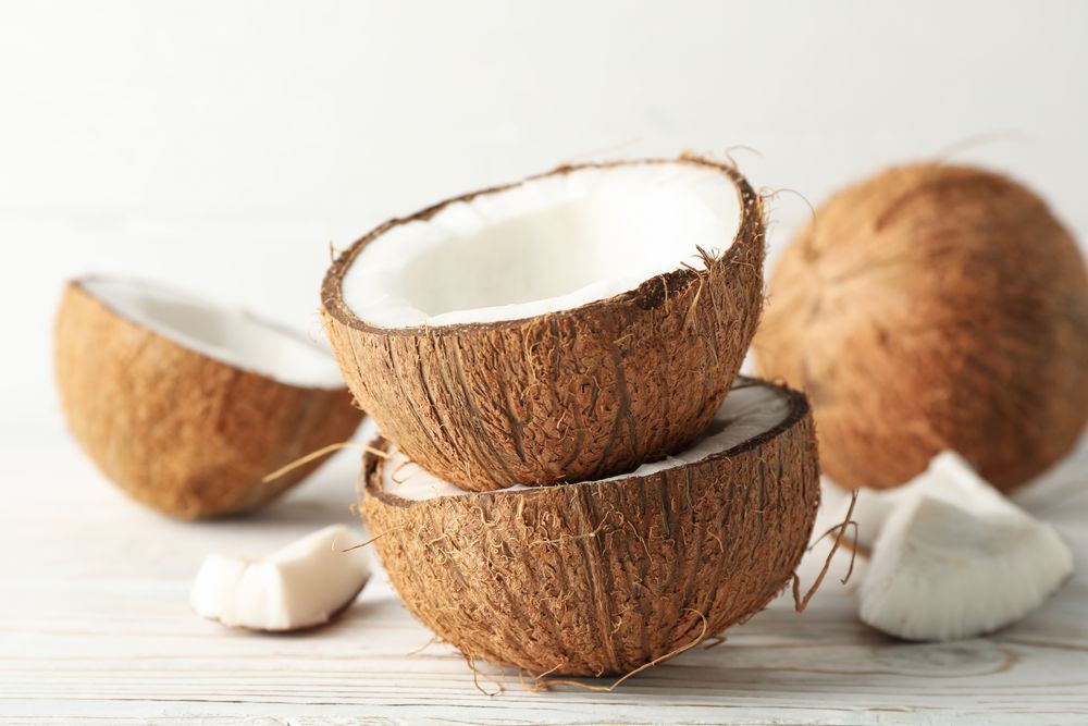 Coconut on wooden background, close up. Tropical fruit