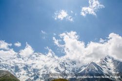 Fairy Meadows Nanga Parbat, clouds in blue sky over snowy mountain range in Pakistan national park 48mrkb