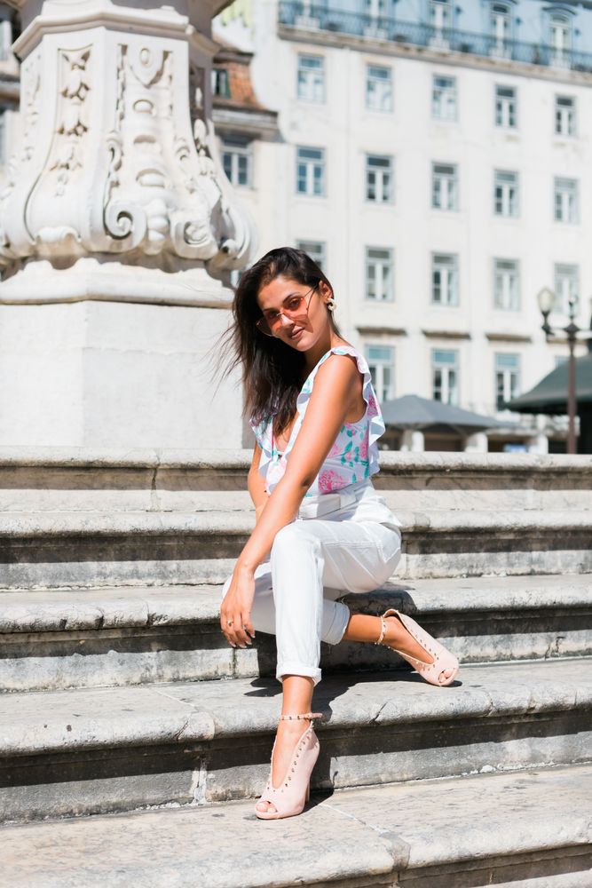 stylish woman in sunglasses sitting in street stairs