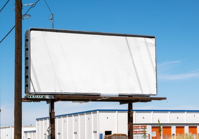 Billboard mockup in industrial area of town on nice day with clear sky