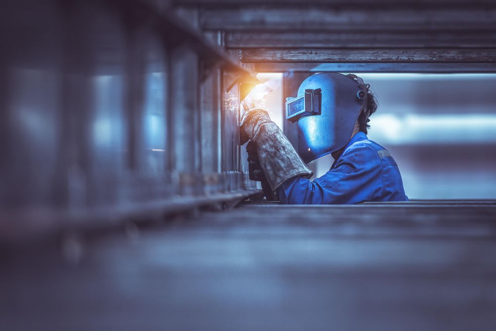 Man wearing welding helmet working
