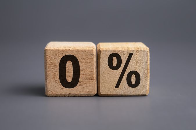 zero percent letter symbol on wooden blocks isolated on grey background. business financial concept