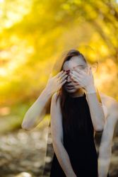 Double exposure shot of woman with hands over eyes