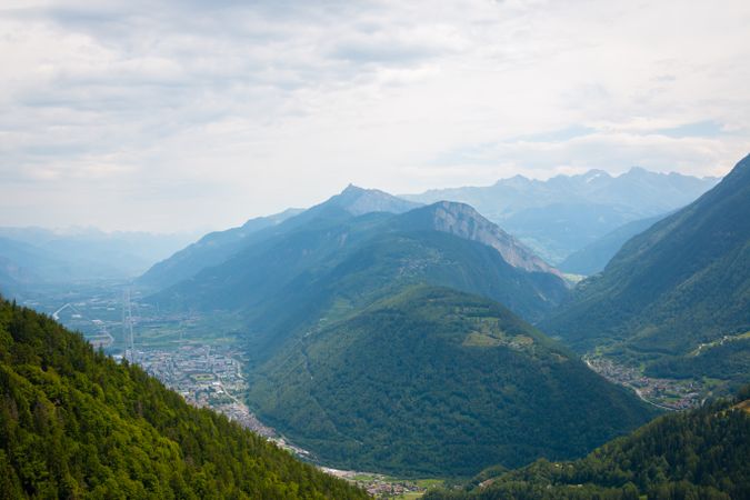 Densely populated town at foot of green mountains