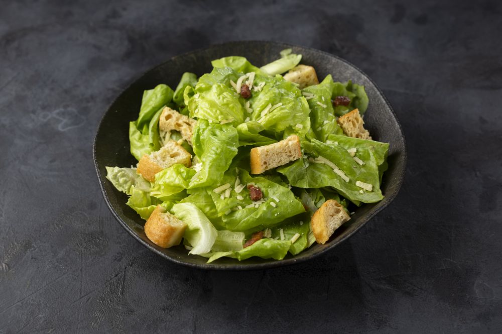 Caesar salad with croutons and bacon.