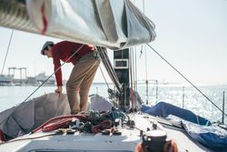 Man arranging boat covering on a yacht