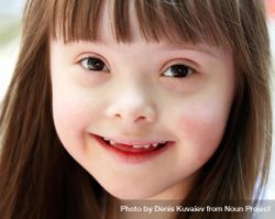 Closeup portrait of a young girl with Down syndrome 5powg0