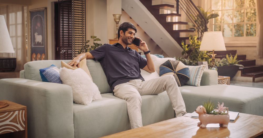 Young Indian Man Talking On His Smartphone, As He Shares His Entrepreneurial Skills with World Of E-Commerce.